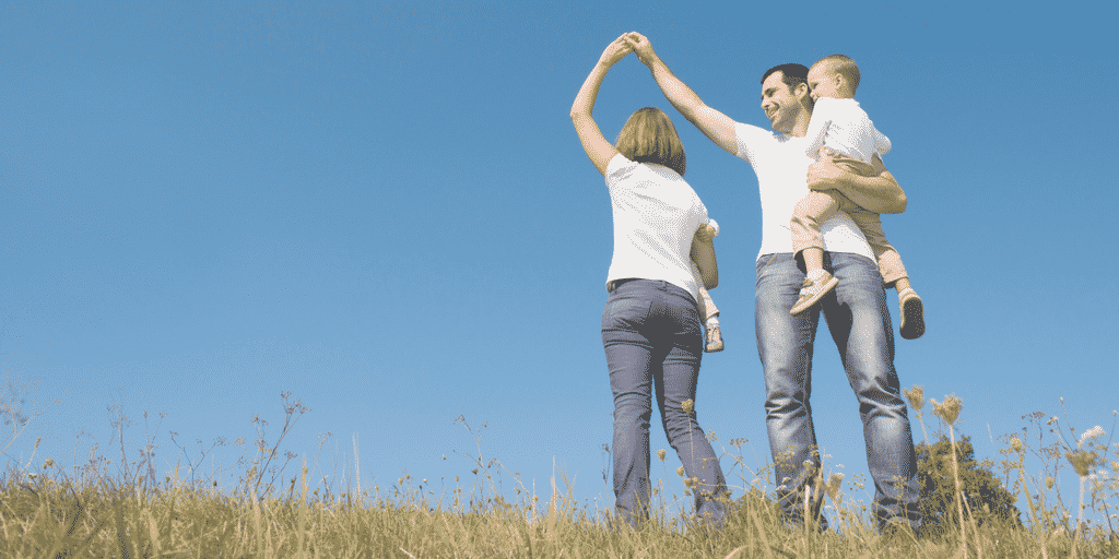 dad spinning mom around and holding baby in a post about making time for family