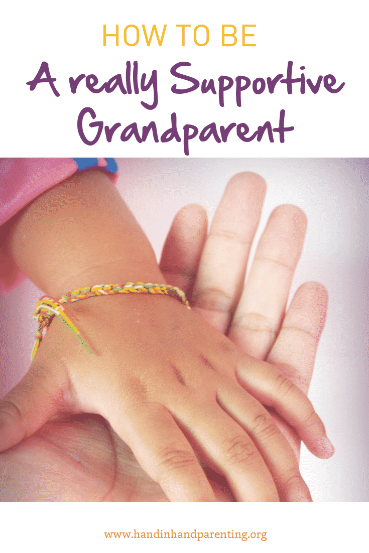 child's hand in grandparents hand