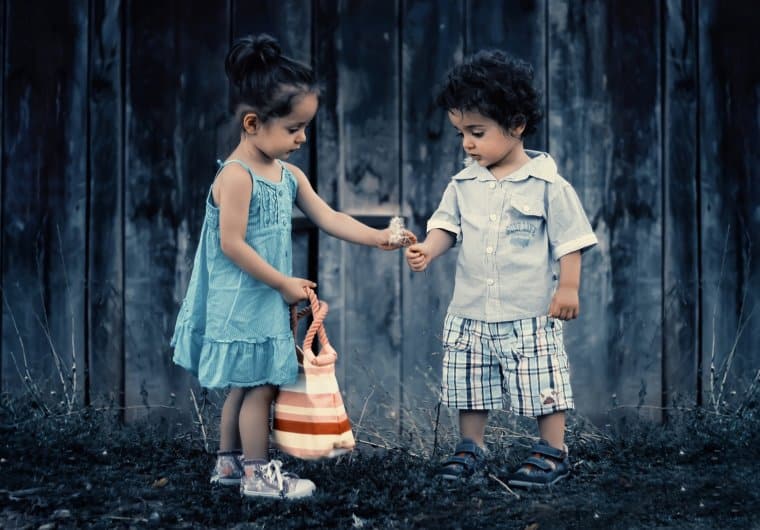 children sharing flower