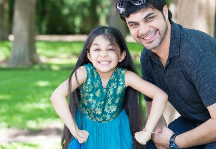 Girl acting grumpy with smiling dad