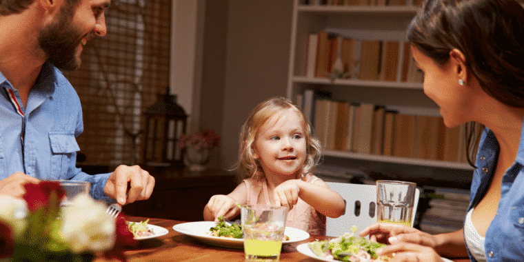 a father, daughter and mom eating at dinner time in a post about avoiding dinner time battles
