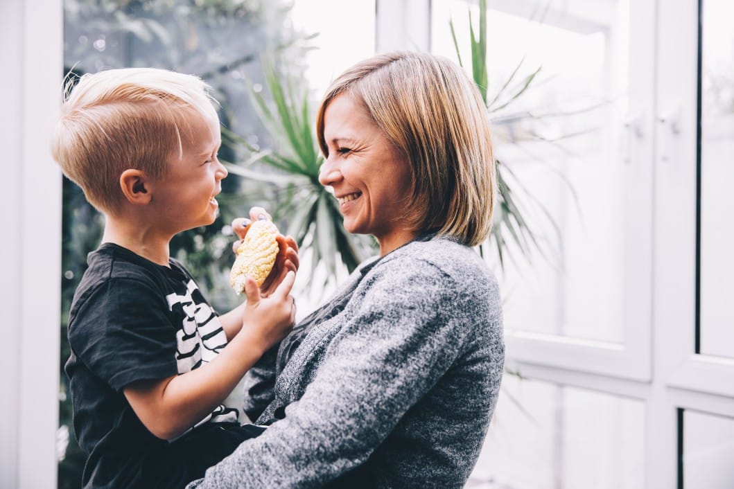 mom laughing with small boy