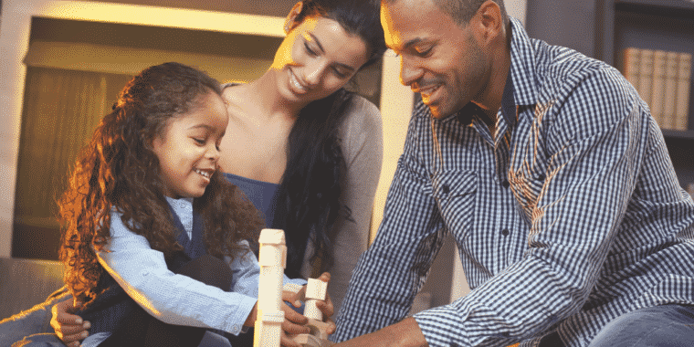 Girl building blocks with mom and dad in post about good ways to play with kids