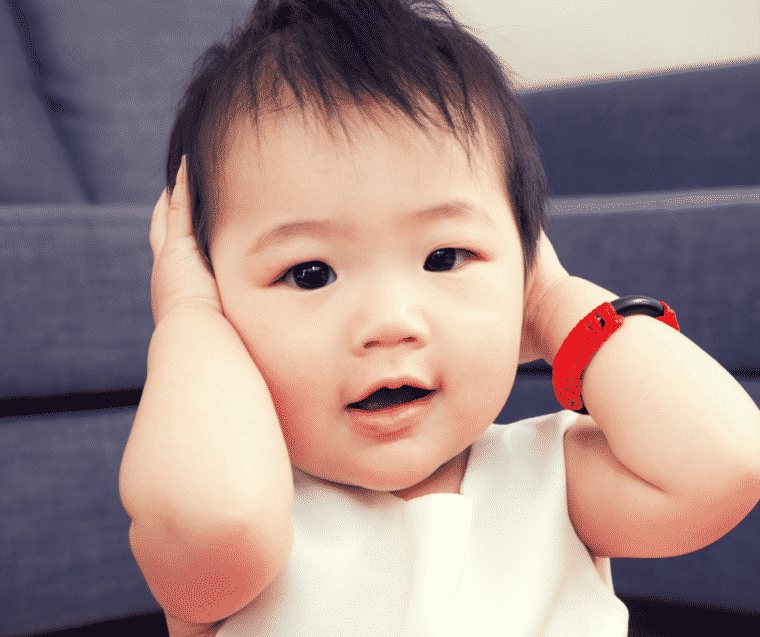 baby with hands in his ears in podcast about getting kids to listen