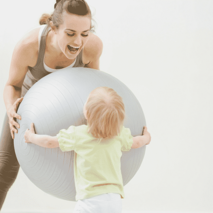mom working out with exercise ball and a baby 