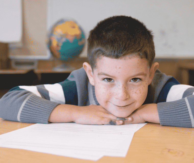 Schoolboy smiling in post about connecting more in the classroom