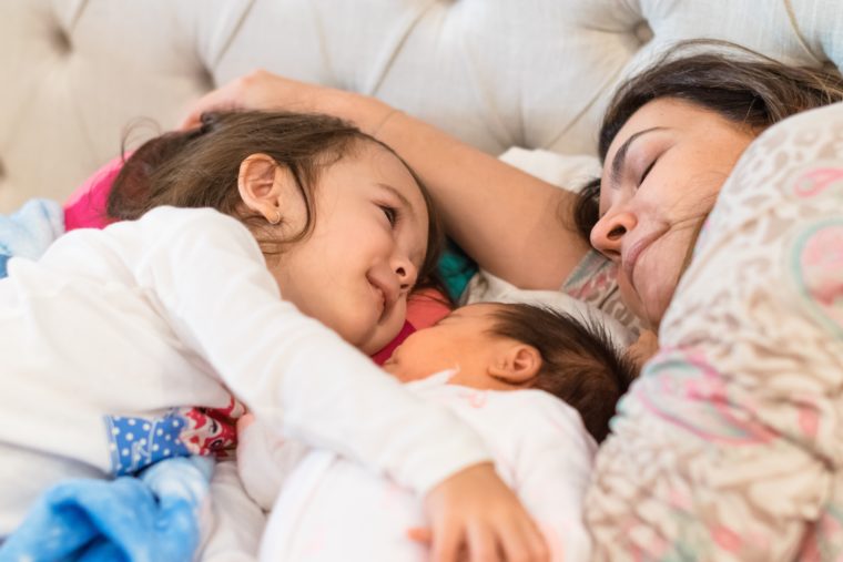 mom, child and baby cuddled up together