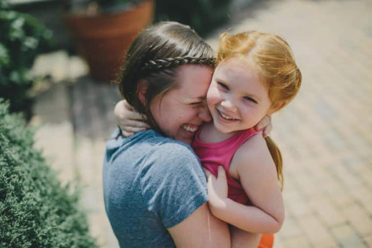 Patient Parent happy mom hugging smiling child