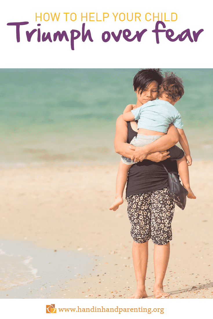 Mom holding boy close on beach in post about overcoming fears