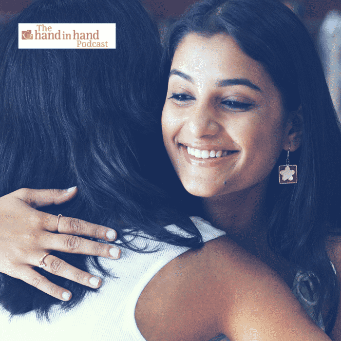 Two moms hugging and smiling, giving support