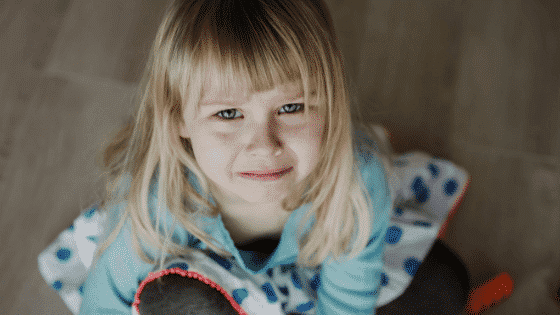 Upset girl crying looking up at camera