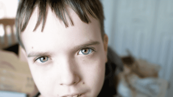 Defiant tween boy glaring