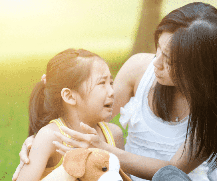 child comforting child who is crying after mom set limits on disruptive behavior