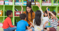 teacher working with resistant child in trauma-informed classroom