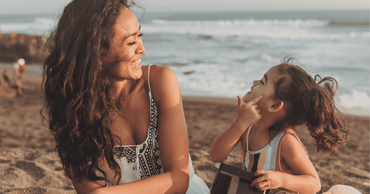 Smiling Mom with mini me daughter who reminds her of herself