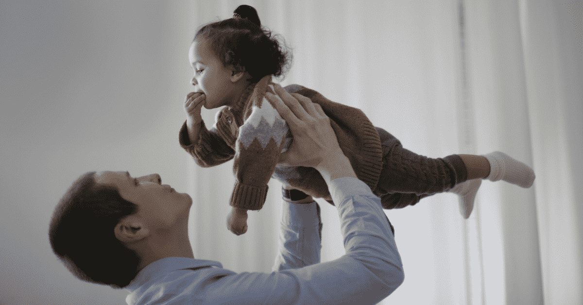 Dad lifting child in air