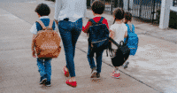 mom walking with four children