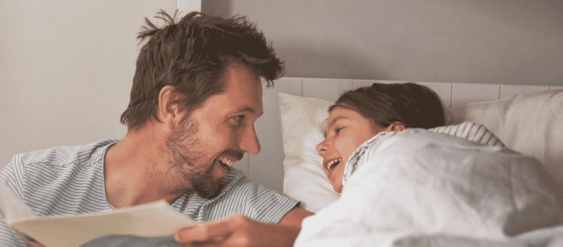 Father and child laughing at bedtime story