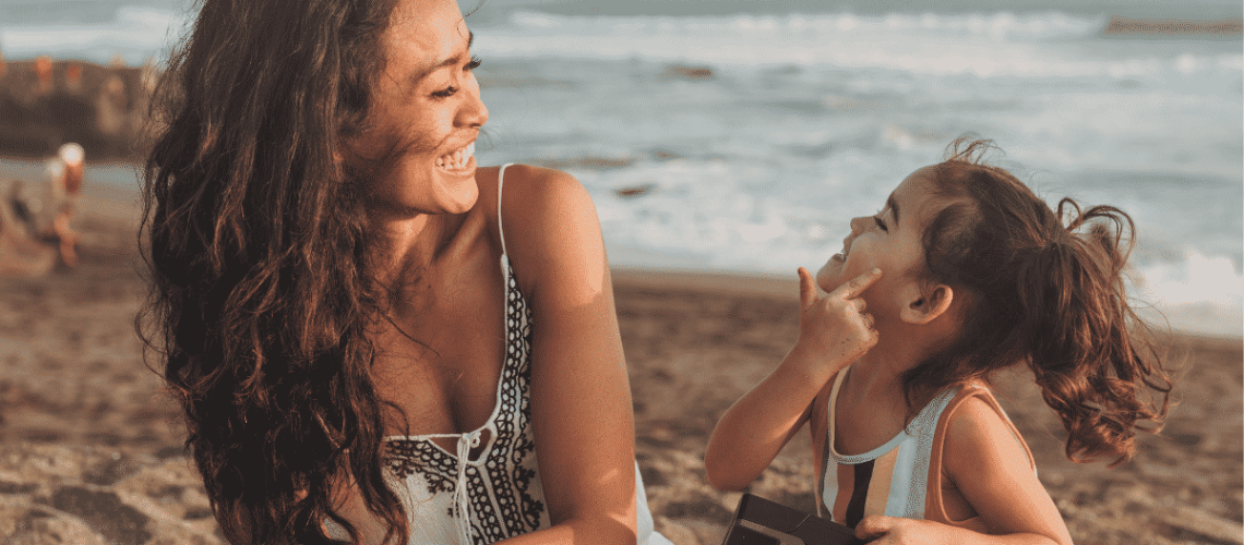 Smiling Mom with mini me daughter who reminds her of herself